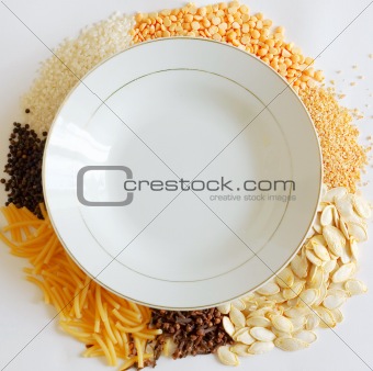 dish with vegenables around on a white background