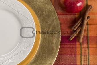 Abstract Fall Colored Table Setting of Apple and Cinnamon with Empty Plate.
