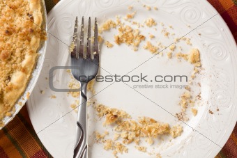 Overhead Abstract of Pie, Empty Plate with Remaining Crumbs Cleared Into Rectangular Copy Room Space and Fork - Ready for Your Own Message.