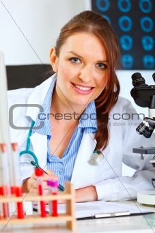 Smiling female medical doctor working at office
