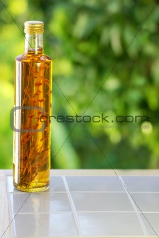 Bottle of vinegar on table.