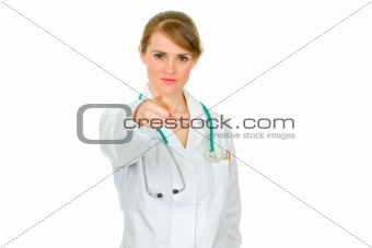 Attractive medical female doctor pointing in camera
