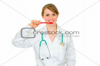 Medical doctor woman with toothbrush showing how to clean teeth properly 
