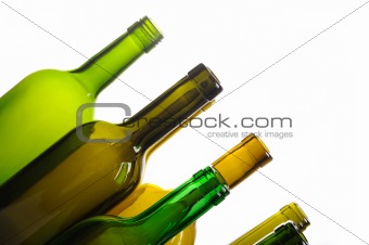 Many empty green wine bottles isolated on white background