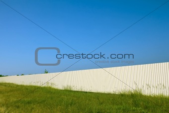 Long white metal fence