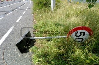 Damaged warning sign or road sign on the street