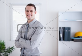 Businessman standing with his arms folded