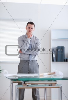Businessman standing behind table