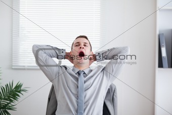 Businessman yawning