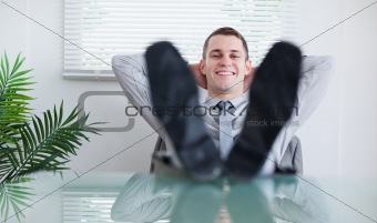 Smiling businessman sitting back