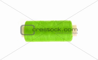 green thread bobbin isolated on white background