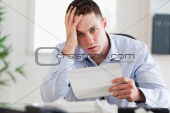 Close up of businessman worried about invoice