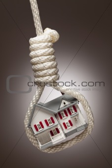 House Tied Up and Hanging in Hangman's Noose on Spot Lit Background.