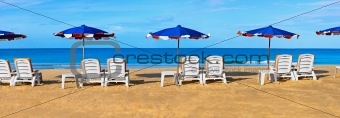 Sunbeds and umbrellas on a tropical beach