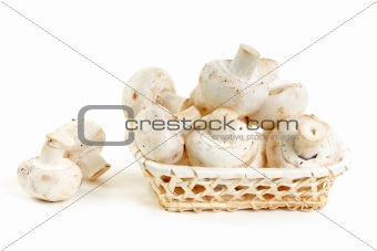 Mushrooms champignon in wooden basket