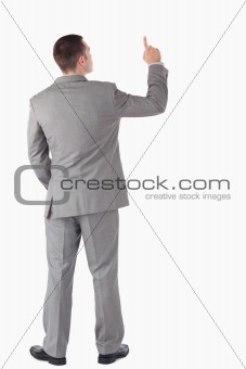 Portrait of a young businessman pointing at something