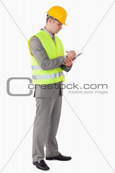 Portrait of a young contractor taking notes