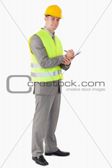 Portrait of a smiling contractor taking notes