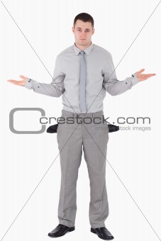 Portrait of a young businessman with empty pockets