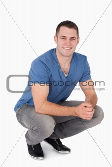Portrait of a man squatting