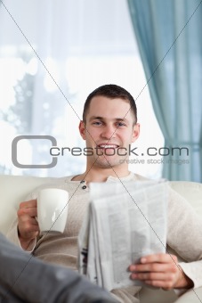 Portrait of a man having a tea while reading the news