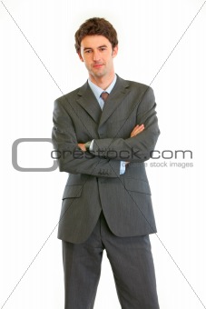 Authoritative modern businessman with crossed arms
