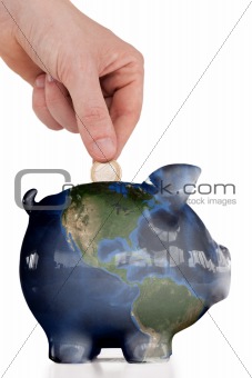 Hand inserting a coin in a pink piggy bank