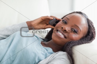 Close up of woman lying on sofa with phone