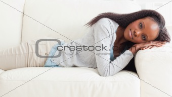 Woman about to take a nap on the sofa