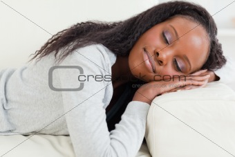 Close up of woman lying on the couch with eyes closed