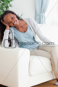 Woman enjoys sitting on the sofa
