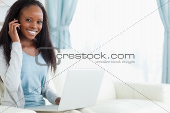 Woman on the phone while working on laptop