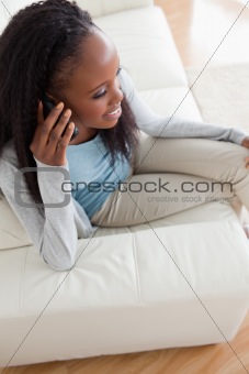 Close up of woman using her phone on sofa
