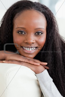 Close up of smiling woman lying on the sofa
