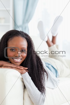 Smiling woman lying on sofa