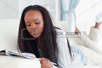 Woman with booklet on couch