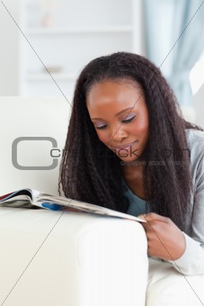 Close up of woman with booklet on couch