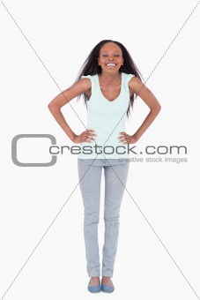 Woman with both arms akimbo on white background