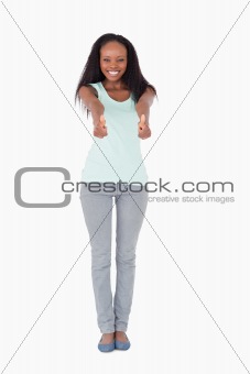 Woman giving thumbs up on white background