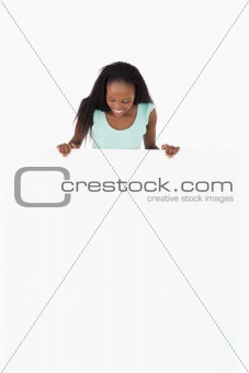 Woman looking at placeholder in her hands on white background