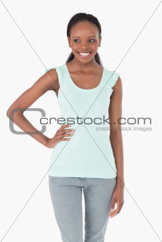 Close up of woman with one arm akimbo on white background
