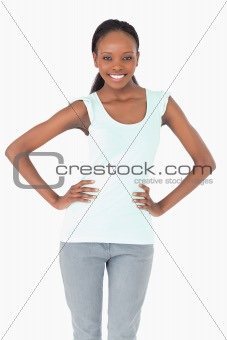 Close up of woman with arms akimbo on white background