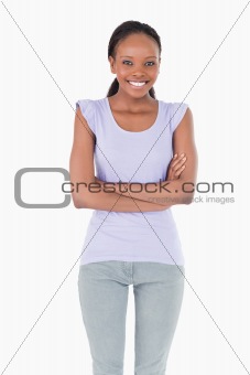 Close up of woman with arms folded on white background