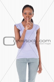 Close up of woman asking for silence on white background