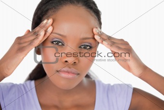 Close up of woman with headache on white background
