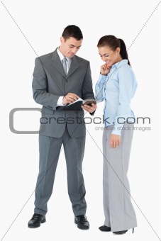 Business partner analyzing documents against a white background