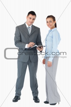 Business team with clipboard against a white background