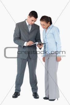 Business partner having a look at a clipboard against a white background