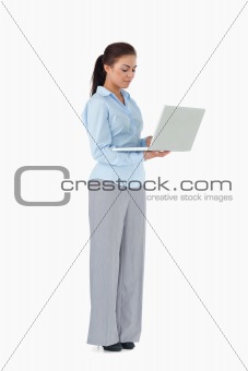 Professional woman working on laptop against a white background