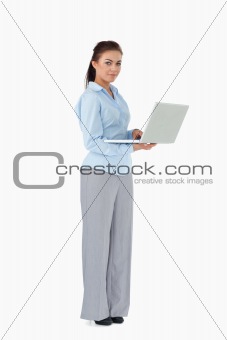 Businesswoman with her laptop against a white background